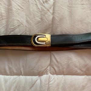 Leather black belt. Gold color with silver color buckle. Used leather condition